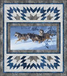 three wolfs are running through the snow in front of a blue and white quilt