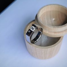 two wedding rings sitting in a wooden box