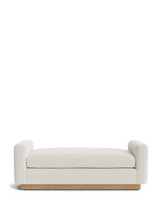 a white couch sitting on top of a wooden frame