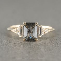 an engagement ring with three stone accents on the sides and two side stones in the middle