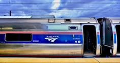 an amtrak train with its doors open at the station