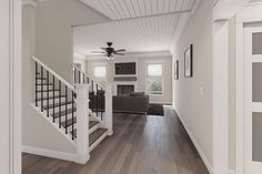 a living room with hard wood flooring and white painted walls, along with a ceiling fan