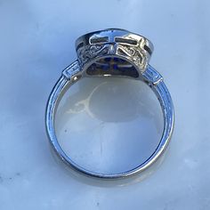 Details: Stunning vintage Art Deco style diamond & sapphire engagement ring. The band is platinum. This is an gorgeous ring with lovely engraving around the shoulders of the band, and has engraving details surrounding the diamond. This ring is stunning! Appraisal Reads: One old European cut diamond, measuring 5.8 x 5.8 x 3.55mm an approx. weight .73ct. with strong blue fluorescences. Clarity VS-2 Color J Cut Very Good Depth 61.2% Table 60.3% Two round brilliant cut diamonds measuring 1.5 x 1 Vintage Blue Sapphire Ring With Diamond Accents, Classic Sapphire Ring With Bezel Setting, Collectible Sapphire Ring With Center Stone In Platinum, Classic Emerald-cut Sapphire Diamond Ring, Collectible Brilliant Cut Sapphire Ring, Classic Sapphire-colored Diamond Ring With Center Stone, Vintage Blue Sapphire Ring With Bezel Setting, Classic Asscher-cut Sapphire Ring With Diamond Accents, Classic Asscher Cut Sapphire Ring With Diamond Accents