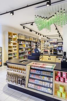 the inside of a grocery store filled with lots of food and drink bottles hanging from the ceiling