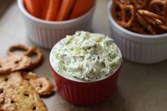 dip and pretzels on a table with crackers