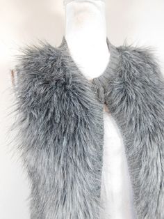 "Vintage 90s Dark Gray Faux Fur Long Hairy Fuzzy Ribbed Minimal Fluffy Sleeveless Open Sweater Vest Jacket Sz Small This item is used but in good condition. Has no rips, tears, staining, and hardly any wear and tear. No sz tag. Appropriate for any casual or evening occasion Measurements: Bust: 34\" Waist: 34\" Hip: 34\" Overall Length: 26\" Domestic Customers: 1st Class Shipping International Customers: Calculated rate (varies by listing due to weight). Any flaws will be noted in item descriptio Fitted Gray Sweater Vest For Winter, Winter Sweater Vest For Cold Weather, Sleeveless Sweater Vest For Winter, Winter Sleeveless Sweater Vest For Cold Weather, Fitted Vest For Winter Layering, Gray Winter Vest For Layering, Hippie Sunglasses, Fluffy Vest, Sweater Vest Jacket