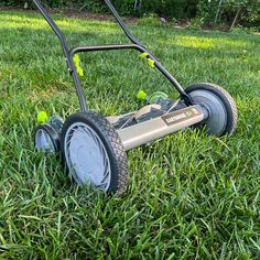 a lawn mower sitting in the middle of some grass