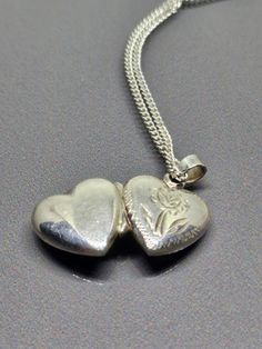 925 Sterling Silver - Mini Heart Etched Design Locket Pendant with Chain ST021 Jewellery Type: Locket Pendant with Chain Metal: Sterling Silver 925 Size: 46cm Chain, Locket 2cm long with 1.6cmx1.2cm Heart Motive: Heart Locket Necklace with Etched Flower Stones: N/A Condition: Not new Item Weight: 4.4gr Items included: Pendant with Chain only Other Comments: None Please note that this is a used item. Items are it very good condition but may need cleaning, Other Comments may contain notes on item Cheap Silver Locket Charm Necklaces, Unique Locket Necklace Silver, Vintage Double Heart Sterling Silver Necklace, Vintage Sterling Silver Double Heart Necklace, Silver Double Heart Necklace With Hallmark, Unique Locket Necklace, Unique Locket, Chain Locket, Locket Necklace Vintage