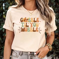 Get into the Thanksgiving spirit with our "Gobble Til You Wobble" shirt! Featuring an adorable turkey holding a pie, this fun and festive tee is perfect for Thanksgiving dinner, Friendsgiving parties, or cozy fall gatherings. It's the ideal shirt for anyone who loves good food and family gatherings. Bring some humor to the table this holiday season with this cute and comfy Thanksgiving tee! This shirt is made with a soft cotton and a quality print that will have you fall in love with it over and Fall Tshirt, Gobble Til You Wobble, Friendsgiving Party, Thanksgiving Tee, Funny Turkey, Autumn T Shirts, Thanksgiving Shirts, Thanksgiving Dinner, Look Plus