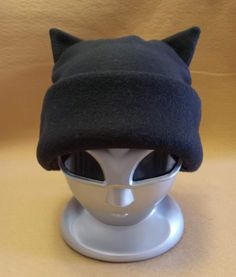 These super fun, unique and soft, fleece Cat Ear Hats are great fun to give and wear! They are all created and handmade by Groovy Moods. Each hat will have your choice of a black, white or grey body with the band and ears available in red, pink, orange, yellow, green, blue, purple, black, white or grey. Great for cat lovers everywhere!  One Size fits child to adult ~ not intended for infants Secondary color shades may vary slightly. Cat Ear Hats, Cat Ear Hat, Cat Ears Hat, Pink Orange Yellow, Bleu Violet, Rose Orange, Green Blue Purple, Cat Ear, Ear Hats