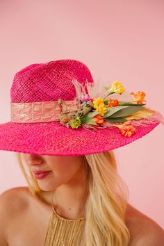 Be the life of the party with this playful CROWD FAVORITE SUN HAT! Featuring a pink leather band, gold horse ornament, and vibrant pink and white feathers, this hat is perfect for a day at the Derby or any summer soiree. Don't forget the fun yellow, orange, and pink flowers for a pop of color. This hat is ONE OF A KIND, created by our owner Stephanie. To receive item quicker, expedited shipping is available at checkout. Chic Pink Summer Hat, Pink Wide Brim Mini Hat For Festival, Pink Summer Hat For Garden Party, Pink Fedora Straw Hat For Summer, Chic Pink Hat For Vacation, Chic Pink Vacation Hat, Pink Hat For Kentucky Derby Festival, Pink Summer Straw Hat For Garden Party, Summer Pink Straw Hat For Garden Party