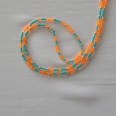 Handmade With Love Tie Yourself Can Be Made For Any Waist Size Message Me With Your Waist Size Ready To Ship Today With Tracking Information. Orange, Teal And Silver Color Pattern Waistbead Orange Beaded Necklace For Summer, Summer Orange Beaded Necklaces, Adjustable Orange Single Strand Beaded Necklace, Orange Beaded Chain Necklace For Summer, Adjustable Orange Beaded Necklaces With Heart Beads, Adjustable Orange Beaded Necklace With Faceted Beads, Summer Orange Beaded Chain Necklaces, Adjustable Orange Beaded Necklace With Heart Beads, Vibrant Orange Handmade Necklace