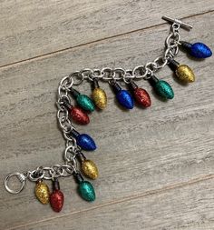 This is for a Christmas Lights Charm bracelet.  Colorful MINI GLITTER lightweight plastic charms on a silver curb chain (nickel-free).  Bracelet measures approx. 7.5 inches long.   Colored MINI bulbs may vary in sequence on each necklace. This is a fun, trendy, and unique piece of jewelry which makes a great gift for someone or for yourself!  PLEASE READ:  Shipping is $3.95.  Please allow 3 business days for handling time.  I only ship within the United States. ALL SALES ARE FINAL.  NO RETURNS ACCEPTED. Plastic Charms, Green Blue Purple, Free Bracelet, Holiday Lights, Bracelet Jewelry, Curb Chain, Silver Charms, Red Yellow, Christmas Lights