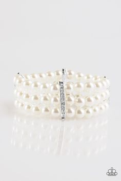 Classic white pearls are threaded along elastic stretchy bands. Encrusted in glittery white rhinestones, shimmery silver fittings join the strands together, creating a timeless look around the wrist. Sold as one individual bracelet. Elegant White Beaded Stretch Bracelet, Elegant Silver Stretch Bracelet With Bling, Elegant Pearl Beaded Stretch Bracelet, Elegant Beaded Pearl Stretch Bracelet, Elegant Pearl White Pearl Stretch Bracelet, Elegant Pearl White Stretch Pearl Bracelet, Elegant Pearl White Stretch Bracelet, White Pearl-embellished Bracelet For Party, Elegant Pearl Stretch Bracelet For Party