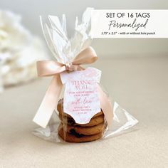 a cookie in a bag with a thank you tag on the front and back of it