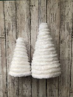 two small white trees made out of yarn