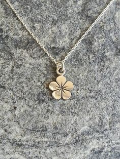 "Sterling silver hibiscus flower necklace. Our tiny flower necklace is solid sterling silver with a smooth shiny finish. It hangs from a small but strong sterling silver chain with a sterling spring clasp. The flower measures 6mm x 6mm and shown here on a 16\" chain. *If you are unsure of the length you need, or would like to wear this item at different lengths, we now offer an adjustable length option! You can add an adjustable end to your necklace using this link: https://www.etsy.com/listing/ Minimalist Silver Flower Charm Necklace, Minimalist Sterling Silver Flower Necklace, Silver Minimalist Flower Shaped Necklace, Minimalist Silver Flower Necklace, Dainty Silver Flower Necklace Nickel Free, Sterling Silver Flower Charm Necklaces, Dainty Sterling Silver Flower Pendant Charm Necklace, Minimalist Sterling Silver Flower Charm Necklace, Minimalist Sterling Silver Flower Shaped Necklaces