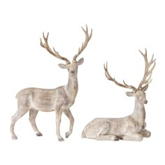 two white deer statues sitting next to each other