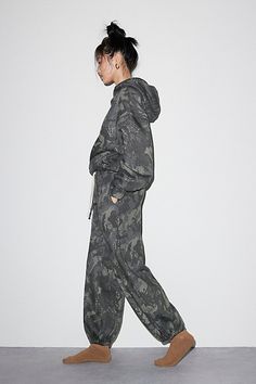 Forever cool Out From Under sweatpant in an oversized, jogger style. Designed in an all-over camo printed knit featuring a low-rise elasticized waistband, drawstring tie and wide balloon legs with cinched hems. Only at Urban Outfitters. Features Out From Under Brenda jogger sweatpant Balloon lounge sweatpant All-over camo print knit Low rise elasticized waistband with drawstring tie Wide balloon legs Cinched elastic hems Oversized, relaxed fit Full length Easy pull-on style UO exclusive Content Camo Sweatpants Outfit, Camo Sweatpants, Christmas 2025, Sweatpants Outfit, Camo Joggers, Xmas List, Camo Hoodie, Fashion Joggers, Camo Print