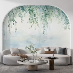 a living room with a couch, table and wall mural in the background that has vines on it