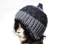 "Styl: warm winter beanie hat with curved ear flaps.  .The perfect hat for autumn and winter days. Material: a mix of yarns of different structure and color. 20% wool, 80% acrylic Color: grey color hat on this picture but you will find other color options on my auctions.You can also compose your color set. Characteristics hat:chunky,soft,warm,unique,colorful Head Circumference: 21\" - 23\" Height: 9\" Very warm, thick hat - perfect for cold winter days. It is made of a blend of acrylic and wool yarn.Hat with contoured earmuffs that perfectly protect ears from cold and wind. This style will make your face look slimmer. If you like unique style, this hat is for you. Warm and soft winter hat. The hat is multicolored. https://www.etsy.com/shop/GreenCatStudio?ref=seller-platform-mcnav&section_i Knitted Beanie With Ear Flaps For Cold Weather, Cold Weather Knitted Beanie With Ear Flaps, Loom Knit Hat, Winter Beanie Hat, Chunky Knit Hat, Cable Knit Hat, Winter Hats Beanie, Winter Beanie, Skull Cap Beanie