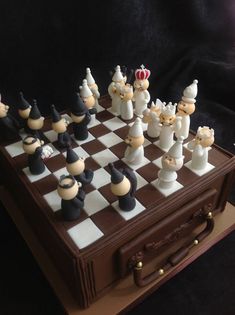 the chess board is made out of plastic and has been placed on top of a wooden box