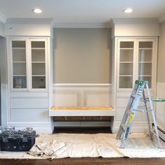 a living room filled with furniture and a ladder