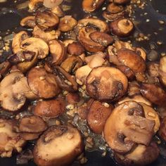 mushrooms are being cooked in a pan on the stove