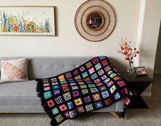 a couch with a crocheted blanket on it