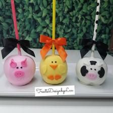 three piggy bank shaped like pigs with bows on their heads, one is pink and the other is yellow