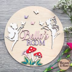 a wooden sign that says, bella's room with mushrooms and butterflies on it