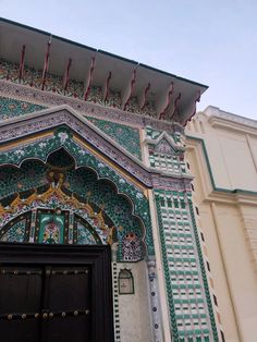 an ornate building with green and white designs