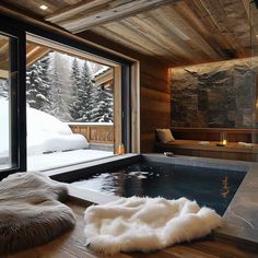 an indoor jacuzzi tub in the middle of a room with snow on the ground