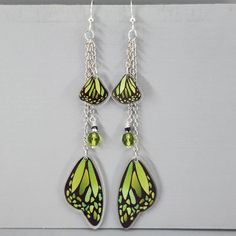 Butterfly Wing Earrings Green Monarch Butterfly Wings Earrings Long Dangle Drop Earrings Magical Fairy Wing Earrings Colorful Wing Earrings I ship super fast.  These super fun lightweight earrings are so pretty. The beads are wire wrapped and connected to the chain.  The wings are connected to the chain.  They are all gathered on a jumpring and connected to the ear wires. The wings are made of resin.  They are double-sided.  The beads are glass crystals.  The chain is non-tranish silver plated a Whimsical Green Hypoallergenic Earrings, Whimsical Butterfly Earrings With Ear Wire, Green Chandelier Earrings As Gift, Whimsical Green Nickel-free Jewelry, Whimsical Butterfly Ear Wire Jewelry, Whimsical Butterfly Jewelry With Ear Wire, Fairy Style Handmade Dangle Earrings, Whimsical Green Dangle Earrings, Fairy-themed Drop Earrings For Gifts