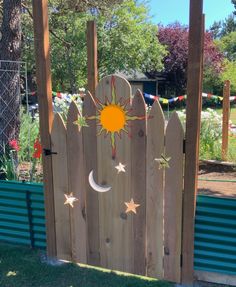 a wooden fence with the sun and moon painted on it