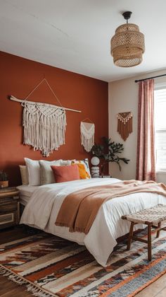 a bedroom with an orange accent wall and white bedding, rugs on the floor