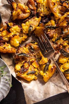 a close up of a plate of food on a table with a fork and knife