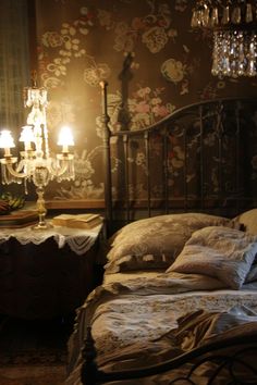 a bedroom with a bed and chandelier in it