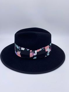 ‘Saija’ is our exclusive signature fedora that exudes luxury vibes like no other. Her name means Crowned Heads in the African language and rightfully so, as she is truly fit for a Queen. ‘Saija’ is not only a top quality fedora but she is a sure head turner and show stopper. Do not be afraid to mix her with other prints and patterns and experiment with other colors to add even more excitement to your entire look. Pair her with a blazer and jeans or a cute dress and heels and you will certainly b Luxury Curved Brim Fedora For Spring, Designer Flat Brim Hats For Spring, Luxury Flat Brim Fedora For Spring, Luxury Brimmed Fedora For Fall, Luxury Spring Fedora Hat, Designer Black Hats For Spring, Modern Fitted Fedora With Flat Brim, Designer Black Spring Hats, Modern Adjustable Fedora With Short Brim