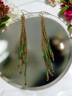 Accessorize your style with these beautiful  beaded fringe earrings, made with seed beads in gold and green. These tassel earrings are casual and fun, the perfect accessory for day or night.  These long dangling earrings can be worn every day and are the perfect gift for a wedding, birthday, Christmas, anniversary, engagement, Mother's Day, Valentine's Day, woman's day, bridesmaid proposal, and many more. ABOUT * Beaded earrings * Fringe style * Measurements: -Height: approximately 4 inches -Width: approximately 1/2 inch  It is recommended that these earrings are stored laying flat or hanging up.  If you like this design but would like a different colour, please message me and I would be happy to make them for you.   Visit my shop for more https://www.etsy.com/shop/FlarecraftArt Gold Beaded Earrings With Beaded Chain For Festival, Gold Beaded Chain Earrings For Festival, Gold Beaded Earrings For Celebration, Green Beaded Earrings With Dangling Beads For Celebrations, Green Dangle Beaded Earrings With Gold Beads, Green Beaded Dangling Earrings For Celebration, Green Dangling Beads Earrings For Celebration, Green Beaded Dangle Earrings For Celebration, Green Beaded Dangling Earrings For Party