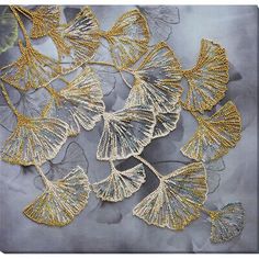 some gold and silver leaves on a gray background