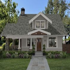 a small gray and white house with two windows on the first floor, front porch and entry door