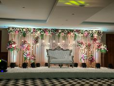 an elegant stage decorated with flowers and greenery for a wedding or event venue,