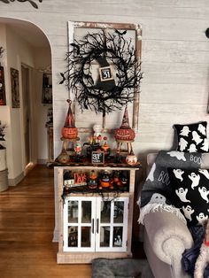 a living room decorated for halloween with decorations on the wall and decor around the fireplace