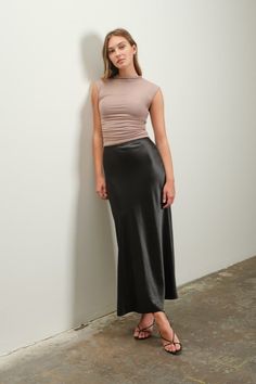 We have had many types of satin skirts in the past, but they always sell out and we always get new ones in because they are a STAPLE in anyone's wardrobe. They go with everything, they can be worn with sneakers or heels, they can be worn through all the seasons and they are comfortable yet sleek and sophisticated. You MUST own at least 2 or 3 in different colors! 98% Polyester, 2% Spandex Imported Model is wearing a Small Black Slip Skirt Outfit, Satin Midi Skirt Outfit, Black Satin Skirt Outfit, Slip Midi Skirt, Satin Skirts, Satin Slip Skirt, Satin Texture, Clubbing Outfits, A Line Cut