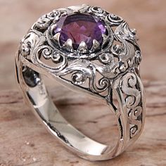 Designed and crafted by Indonesian artisan Agung Jagra this ring features a 1.5 carat amethyst. Sterling silver leaf and swirl designs outline the faceted stone and twist down the side of the ring's band. Purple Amethyst Ring With Intricate Design, Purple Amethyst Ring With Intricate Design For Promise, Purple Amethyst Promise Ring With Intricate Design, Purple Promise Ring With Intricate Design, Purple Intricate Design Promise Ring, Sterling Silver Amethyst Promise Ring With Intricate Design, Ornate Amethyst Purple Ring, Ornate Purple Amethyst Ring, Intricate Design Purple Amethyst Ring