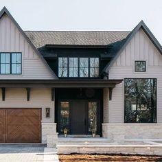 a large house with two garages and three windows