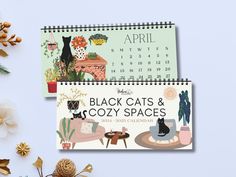 two calendars with black cats and cozy spaces on them next to christmas decorations, pine cones and flowers