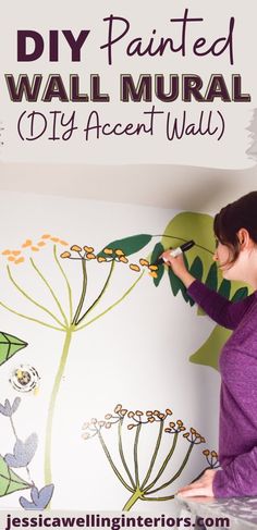 a woman is painting a wall mural with flowers