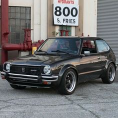 a black car parked in front of a building